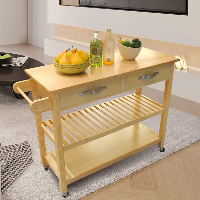 Un chariot d'îlot de cuisine à roulettes avec deux tiroirs et des étagères ouvertes.