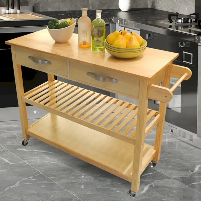 Un chariot d'îlot de cuisine à roulettes avec deux tiroirs et des étagères ouvertes.